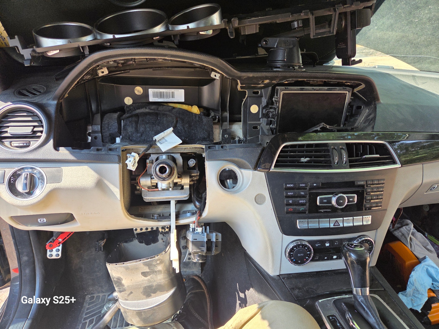 Mercedes-Benz C300 dashboard disassembled to access steering lock and ignition for key replacement