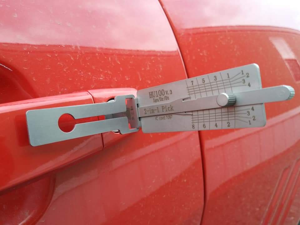 HU100 2-in-1 lock pick used on a red GM vehicle door for a non-destructive lockout